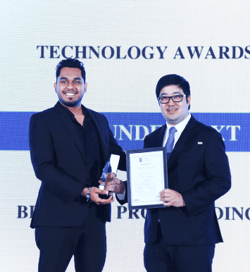 Leaders at FundedNext Accepting Award on Stage